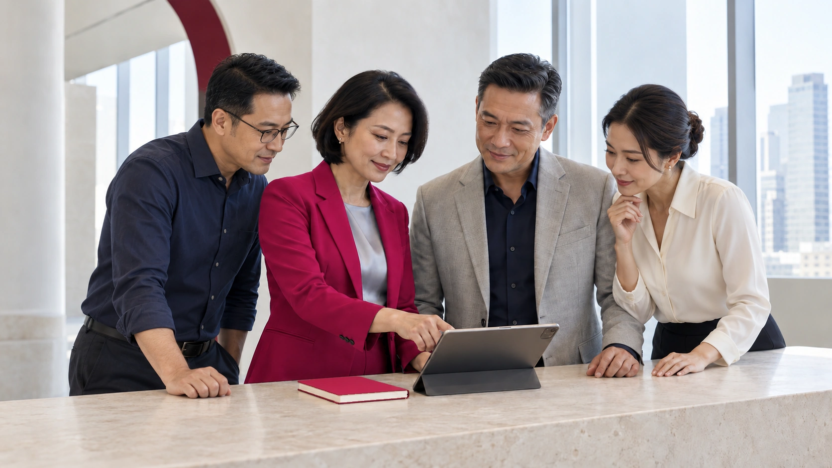 Indonesian managers collaborating around a tablet naturally oriented toward the team.