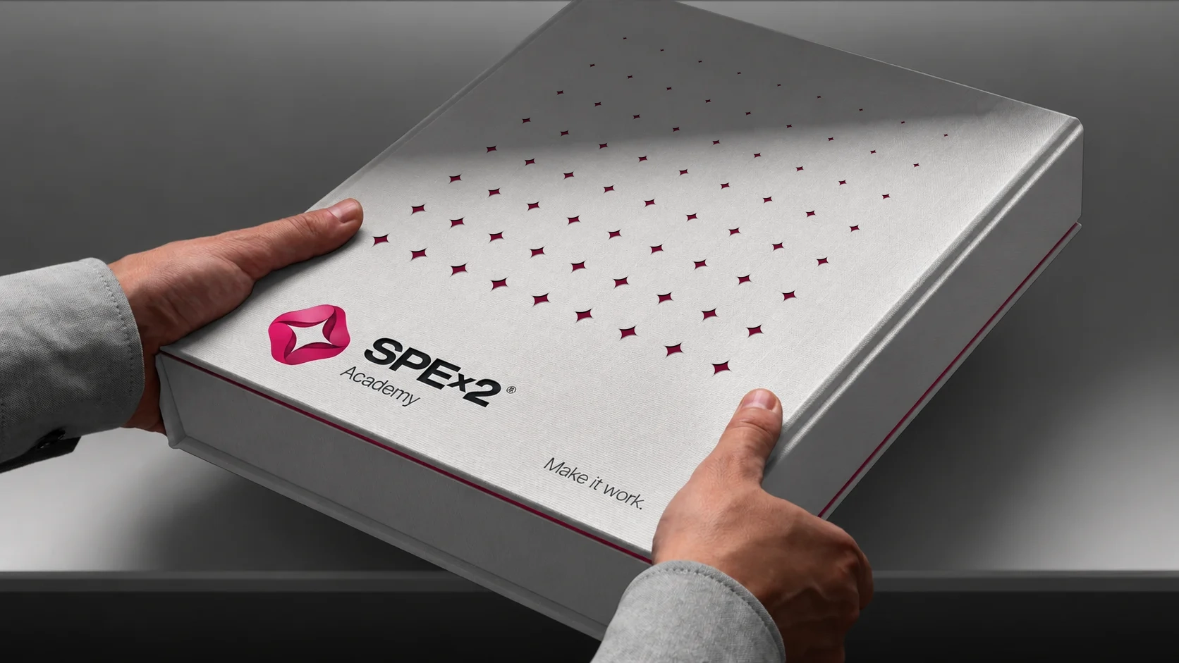 Silver SPEx2 Academy presentation box with graduated star-shaped cutouts.