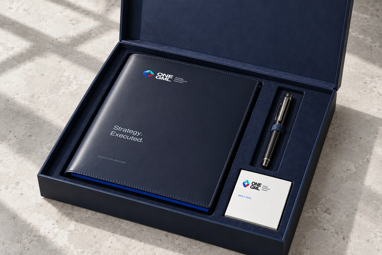 A bespoke navy suede-lined presentation case with ONE GML calfskin folio, ruthenium pen and thick ivory executive card.