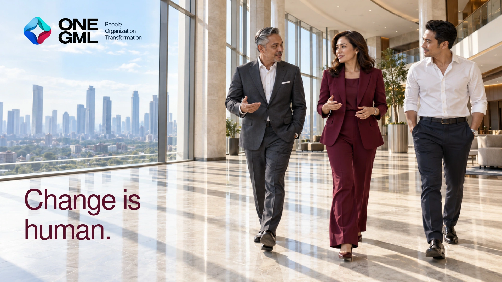 Three Indonesian executives walking together in a bright Jakarta atrium, with a clear ONE GML logo against the open skyline. Change is human.