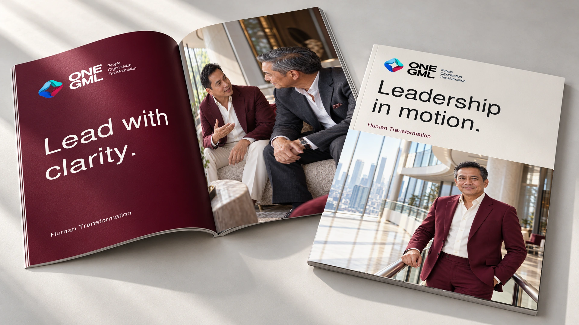 Leadership in motion. ONE GML Human Transformation report with an Indonesian male executive on the ivory cover and two Indonesian men in dialogue on the open photo page, beside the burgundy Lead with clarity page.