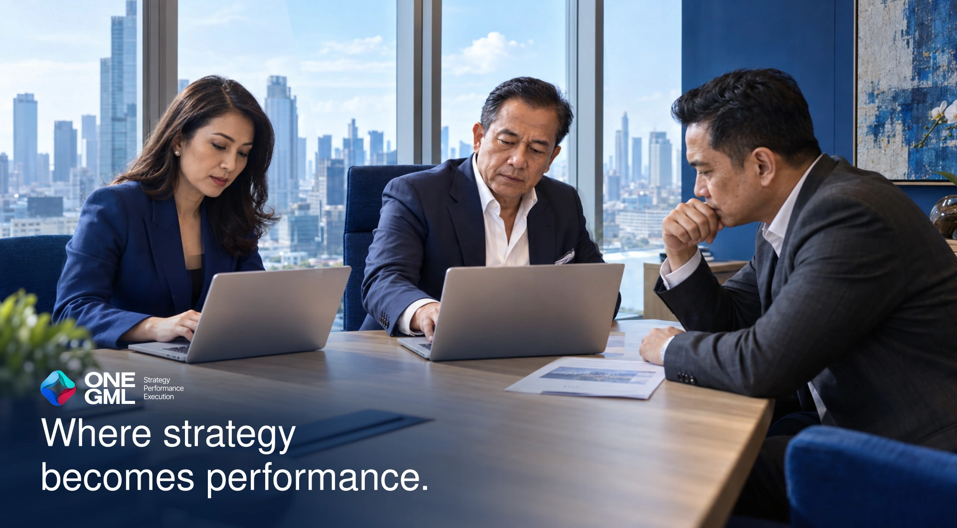 Three Indonesian executives working together around a boardroom table. Where strategy becomes performance.